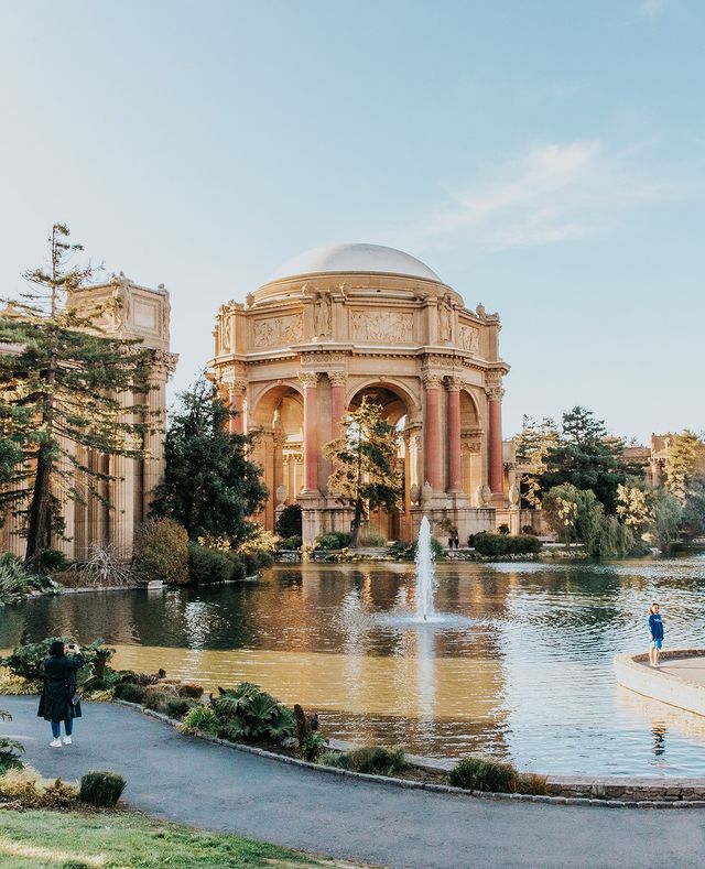Quinceanera at Palace of Fine Arts, a couple of people walking around a pond in San Francisco