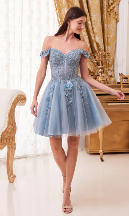 Quinceanera image of a woman standing in a room wearing a blue cocktail dress