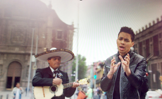 Quinceanera event with Prince Royce, featuring a couple of men standing next to each other on a street