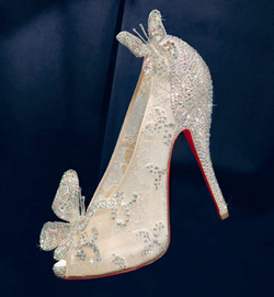 A pair of high-heeled Christian Louboutin Cinderella Slipper shoes with bows on them, perfect for a Quinceanera event.