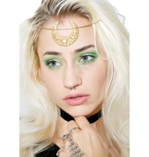 A beautiful woman with gold headpiece and green eyeshadow, showcasing her hair coloring for Quinceanera