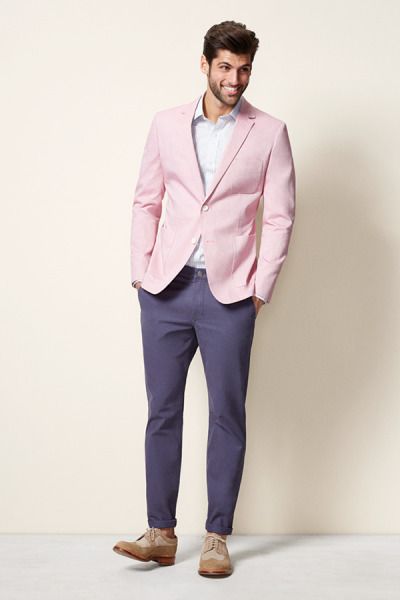 A man in a pink jacket and blue pants wearing a Quinceanera blazer
