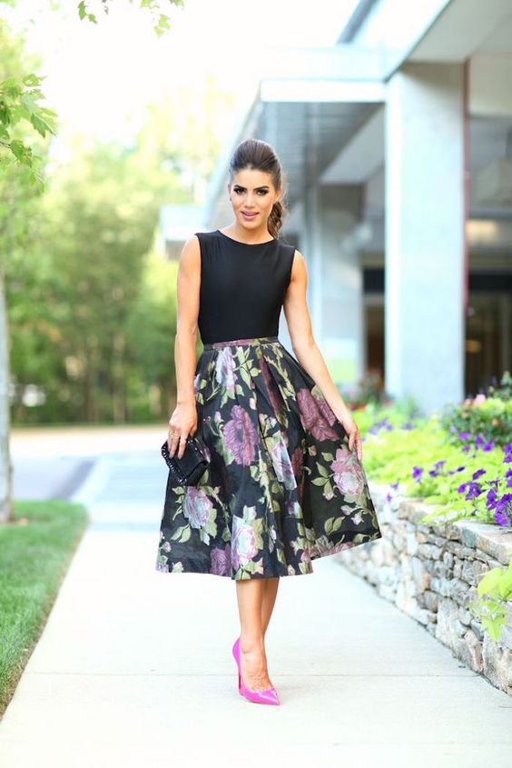 A fashionable Quinceanera model walking down a sidewalk in a floral skirt