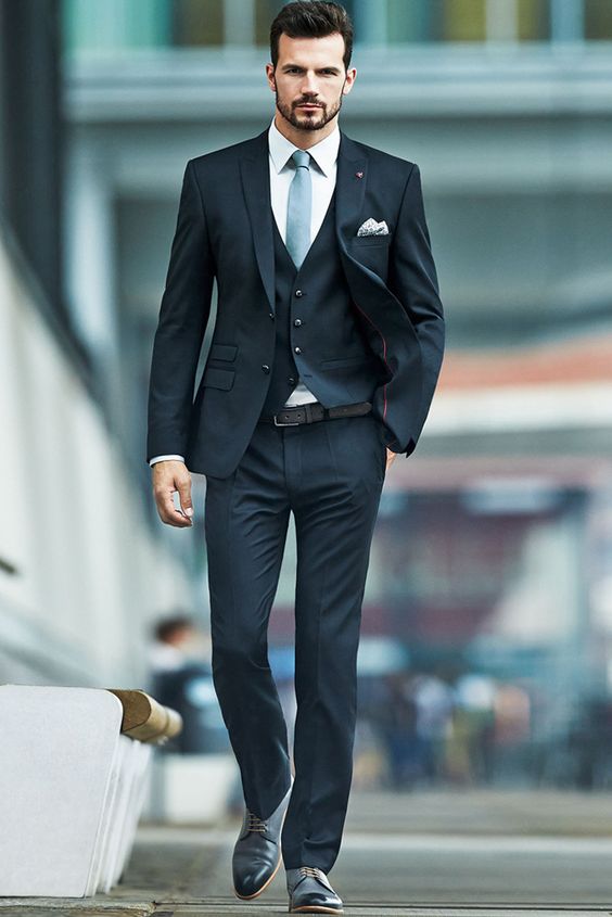 A man in an American suit for Quinceanera, walking down the street.