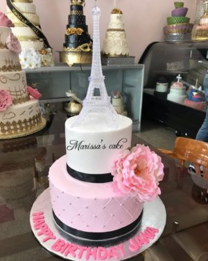 Quinceanera Paris themed three-tiered cake with the Eiffel Tower on top