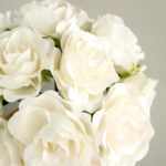 Floral design of red roses on a white surface, perfect for a Quinceanera celebration