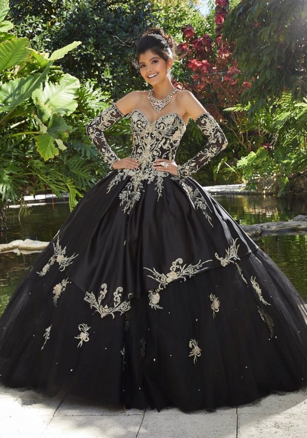 A woman wearing a black and gold ball gown for Quinceañera, similar to Morilee quinceanera dresses