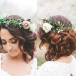 Quinceanera woman with a floral crown on her head, sporting a bridal updo hairstyle