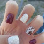 Quinceanera-inspired cute fall nail design featuring a hand with a manicured manicure and a flower design