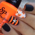 Quinceanera nail designs with cute black and orange polish