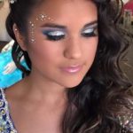 Quinceanera hairstyle, woman with long hair wearing a blue dress, accessorized with hair accessories