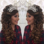 A woman with long hair wearing a quinceanera headpiece and a tia hairstyle.