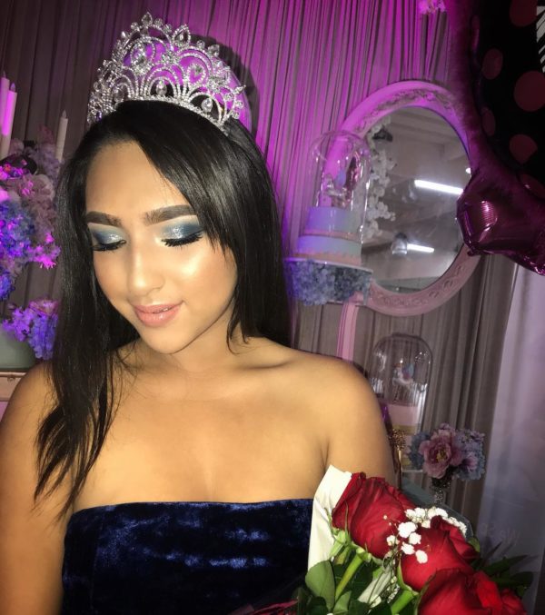 Beauty, a woman in a blue dress holding a bouquet of roses, Quinceanera