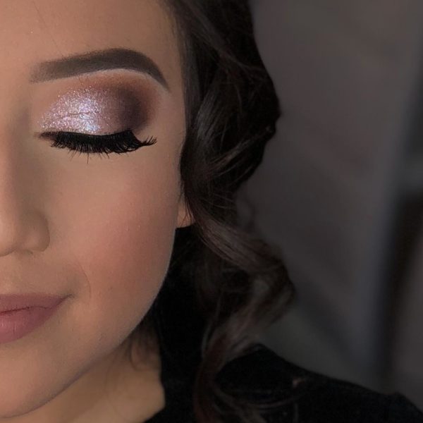 A close up of a woman's face with natural makeup for Quinceañera