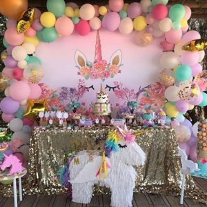 Over the top Quinceanera party decorations with a unicorn theme, including balloons and decorations