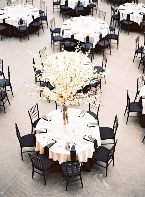 Black and white Quinceanera theme: A table with a vase of flowers on top of it