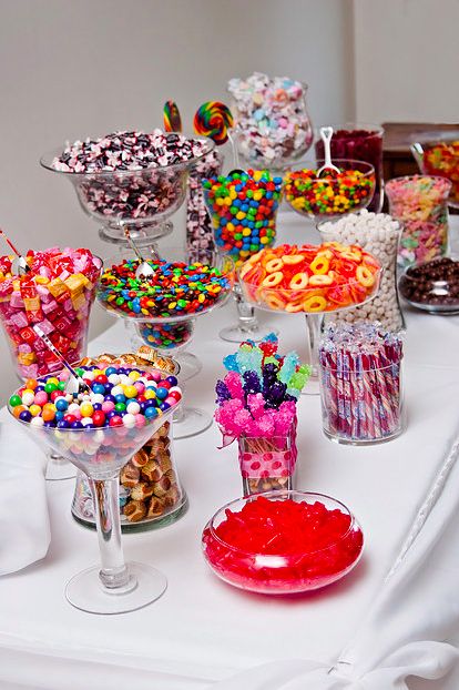 A Quinceanera sweet table filled with different types of candy