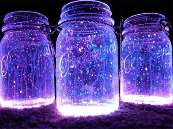 Three mason jars with glowing lights in them, DIY Galaxy themed Quinceanera decoration