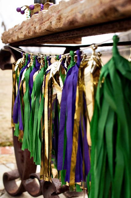 Quinceanera celebration with Mardi Gras vibes in New Orleans, featuring a wooden pole adorned with colorful tassels