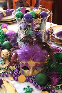 Quinceanera table, a table topped with lots of purple and green decorations for a Mardi Gras theme