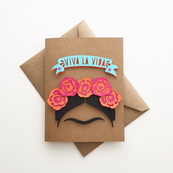 A Quinceanera party box with a card featuring a mustache design and flowers.