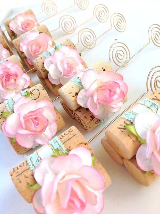 A close up of a bunch of wine corks with flowers on them, used as petal Bomboniere for a Quinceanera celebration