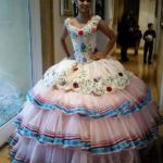 A woman in a ball gown posing for a picture wearing Quinceañera dresses
