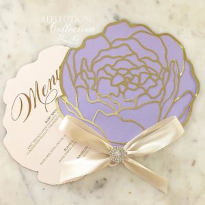 A purple and gold Quinceanera invitation with a bow