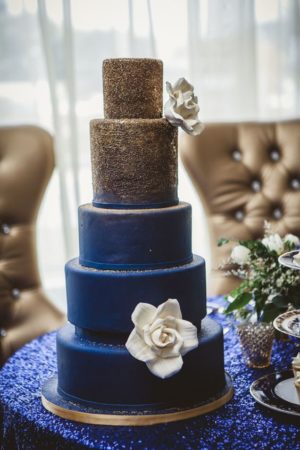 Quinceanera image: navy blue wedding motif Wedding Invitation, a three tiered blue cake on a table