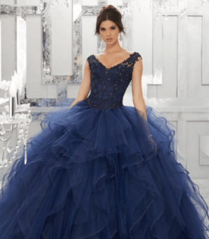 A woman in a ball gown posing for a picture, wearing shades of blue Quinceanera Quinceañera dresses.