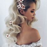 A Quinceanera woman with long blonde hair and a flower in her hair, showcasing a trendy emo 2023 hairstyle.