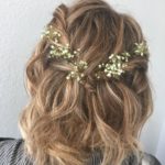Quinceanera hairstyle, a woman with blonde hair and a flower in her hair