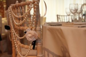 A close up of a chair with pearls on it, perfect for a Quinceanera celebration