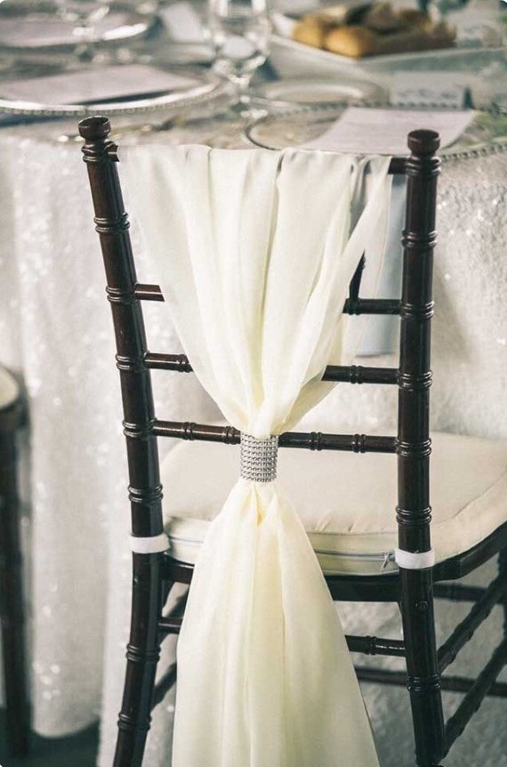 A Quinceanera themed image with a chiavari chair adorned with a white sash tied to it