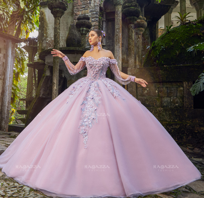 A woman in a pink ball gown posing for a picture wearing Quinceañera dresses
