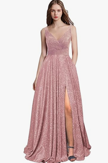 A woman wearing a long pink Quinceanera dress with a slit, perfect for a day dress or Prom dresses.