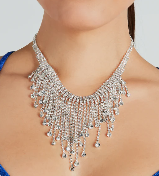 A close up of a woman wearing a Quinceanera necklace