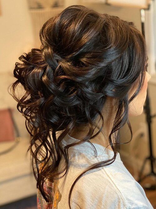 A close up of a person with long hair styled for a Quinceanera