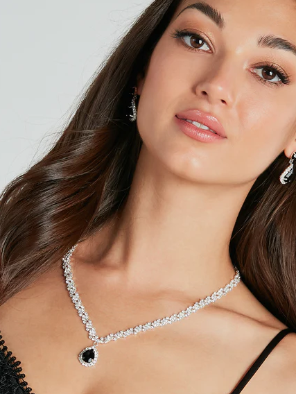 Quinceanera beauty Windsor, woman in a black dress wearing a necklace and earrings
