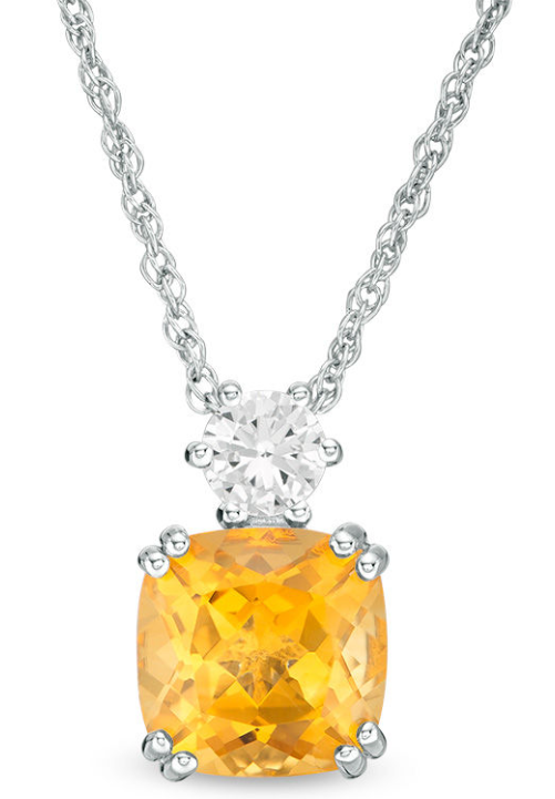 A stunning pendant earring and necklace set featuring a yellow stone and a sparkling diamond, perfect for a Quinceanera.