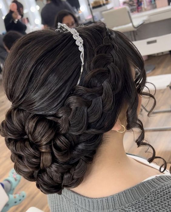 A woman with long hair getting her Quinceanera hairstyle done in a salon