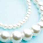 A close up of a Quinceanera pearl necklace and bracelet.