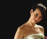 A beautiful Quincea&ntilde;era woman in a Quinceanera dress holding a bouquet