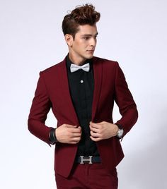 A man in a red suit and bow tie, wearing a red color suit for Quinceanera event.