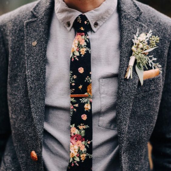 A quinceañera celebration featuring a young man dressed in a hipster suit with a tie adorned with flowers.