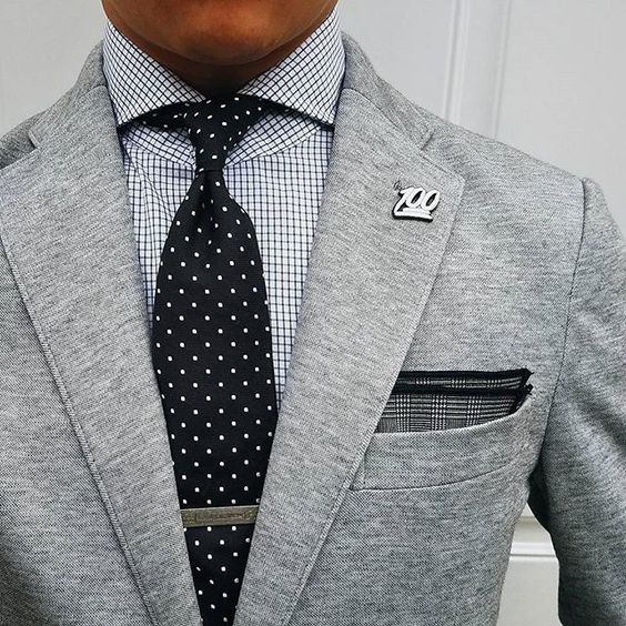 A close up of a person wearing a quinceanera blazer with a necktie