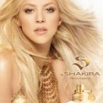 A Quinceanera girl with long blonde hair holding a bottle of perfume by Shakira