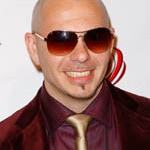 A bald man wearing sunglasses and a suit, posing for a Quinceanera photoshoot with Pitbull