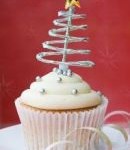 A Quinceanera themed cupcake with a Christmas tree on top of it