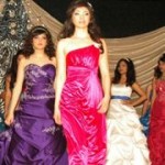 A group of young women in Quinceanera gowns walking down a runway
